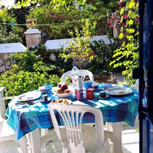 a table with a blue and white table cloth on it at Villetta IRENULLA in Posidhonía