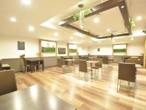 a dining room with tables and chairs in a building at APA Hotel Nagoya Sakae Ekimae EXCELLENT in Nagoya