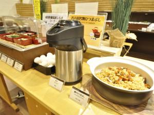a counter with a mixer and a bowl of food at APA Hotel Nagoya Sakae Ekimae EXCELLENT in Nagoya