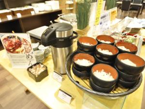a table topped with bowls of food on a counter at APA Hotel Nagoya Sakae Ekimae EXCELLENT in Nagoya