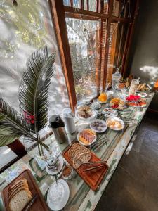 a table with a buffet of food on it at Hospedagem Tulipane - Praia do Campeche in Florianópolis