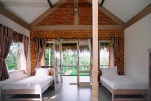 Postel nebo postele na pokoji v ubytování Novia Guest House Lombok-Tetebatu