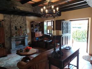 a living room with a couch and a fireplace at Gran Pedroso de Llanes in Llanes