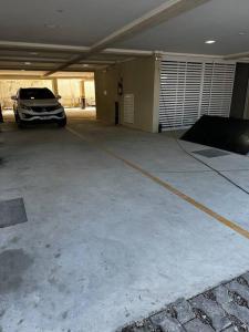 a parking garage with a car parked in it at Cobertura 402- 2 Dormitórios Praia de Bombas in Bombas