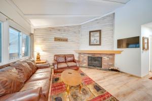 a living room with a couch and a fireplace at Near Hiking Renovated Breck Condo with Tennis Court in Breckenridge