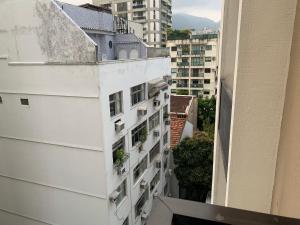 a view from the balcony of a white apartment building at Flat Leblon inn in Rio de Janeiro