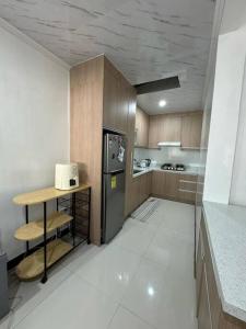 a small kitchen with a refrigerator and a counter at 3Bed&Bath family friendly house in Davao City +40 photos