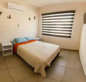 a bedroom with a bed and a large window at House with pool near Riviera Nayarit beaches in Los Algodones