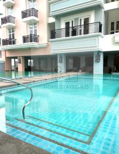 a swimming pool in front of a building at Homestayed ilo in Iloilo City