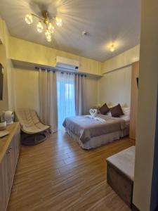 a hotel room with a bed and a window at Homestayed ilo in Iloilo City