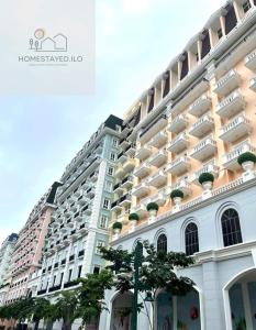 a large white building with balconies on it at Homestayed ilo in Iloilo City