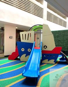a childrens playground with a blue slide in a building at Homestayed ilo in Iloilo City