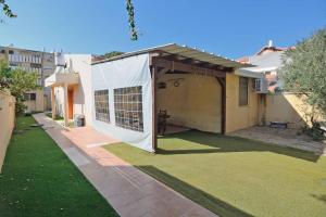 a white cover over a yard with a house at Domik by the sea in Haifa