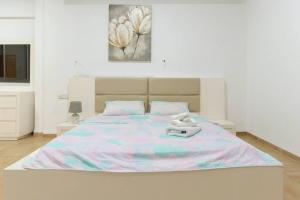 a bedroom with a large bed with towels on it at Domik by the sea in Haifa