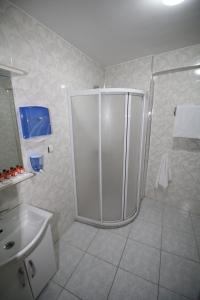 a bathroom with a shower and a sink at Selimiye Hotel in Edirne