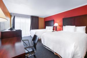 Ένα ή περισσότερα κρεβάτια σε δωμάτιο στο Pullman Garden Inn