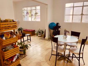 a dining room with a table and chairs in a room at Acogedora Habitación en el Centro Histórico, CDMX in Mexico City