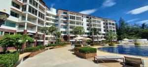 a large apartment building with a pool in front of it at Seaview Condominium A13 in Ban Tha Fat