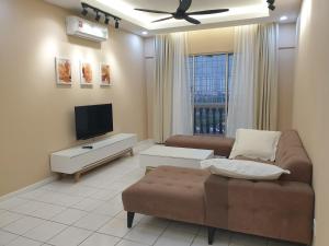 a living room with a couch and a flat screen tv at Sri Raya Apartment Bandar Baru Bangi in Kajang