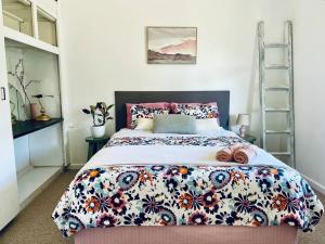a bedroom with a large bed with a floral bedspread at Pet Friendly Cottage on Large Sunny Block & 5 mins-CBD in Canadian +39 photos