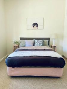 a bedroom with a large bed in a room at Updated Cottage on Large Sunny Block - 5 mins-CBD in Canadian +32 photos
