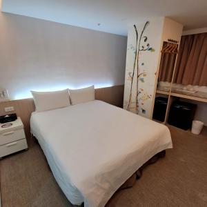 Ένα ή περισσότερα κρεβάτια σε δωμάτιο στο Morwing Hotel Fuzhong