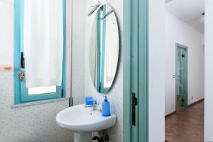 a bathroom with a sink and a mirror at 'Casa di Vivi' 300m from the beach Free Wifi Netflix in Moneglia +19 photos