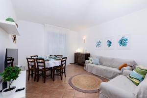 a living room with a couch and a table at 'Casa di Vivi' 300m from the beach Free Wifi Netflix in Moneglia