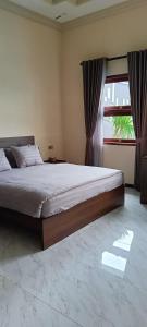 a bedroom with a large bed and a window at Dream Hills Villa in Batu +45 photos