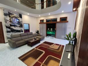a living room with a couch and a table at Dream Hills Villa in Batu