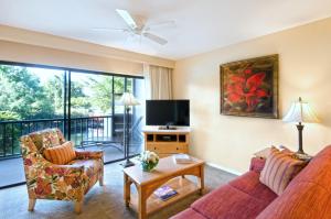 a living room with a couch and a tv at Park Shore Resort by Sunstream in Naples