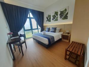 a bedroom with a bed and a large window at Swan Garden Resort Hotel in Melaka