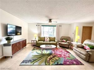 a living room with a couch and a table at Beautiful 3 Bed House with pool in North Fort Myers
