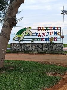 a sign on a fence with a turtle on it at Lin's Homestay in Port Dickson