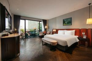 a hotel room with a bed and a balcony at Le Premier Hotel & Rooftop Bar in Hanoi