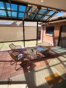 two chairs and a table on a patio at Lbarza Charming & Convenient 3BR Home close to Hospitals & Sporting Grounds in Shepparton