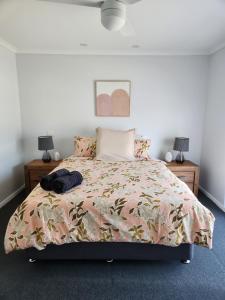 a bedroom with a bed and two night stands at Lbarza Charming & Convenient 3BR Home close to Hospitals & Sporting Grounds in Shepparton