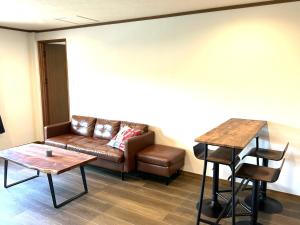 a living room with a couch and a table at 三千の二階 in Meinohama