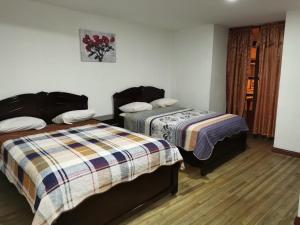 a bedroom with two beds at Hostal Palma in Cuenca