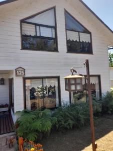 a house with a light in front of it at Casa Lago Ranco in Lago Ranco