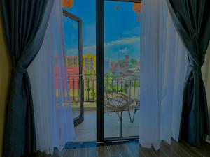 a room with a window with a view of a balcony at The Night Market Villa 1 - Near Hoi An Old Town 200m in Hoi An +22 photos