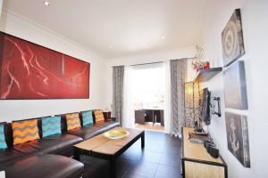 a living room with a couch and a table at HolidayRento 2BR Beachfront Building on Bondi Beach in Sydney
