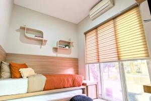 a bedroom with a bed and a large window at Cottonwood Villa Kuantan Jogja - Pool Netflix Gym in Ngabean +22 photos