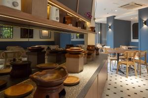 a restaurant with wooden stools and tables and chairs at Hotel 88 Kedoya Jakarta in Jakarta