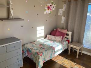 ein kleines Schlafzimmer mit einem Bett und einer Kommode in der Unterkunft 94 on Main in Kiddʼs Beach