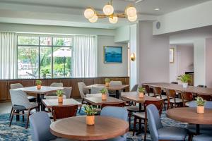 a restaurant with tables and chairs and a large window at Residence Inn by Marriott Boston Harbor on Tudor Wharf in Boston