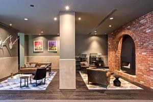 a living room with a brick wall and furniture at Entire 1 BR Southbank Apartment - Gym Pool Sauna 1 step to Crown Casino in Melbourne