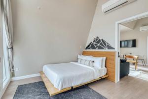 a bedroom with a bed and a mirror at Stardust Big Bend Luxury A-Frame#1 with a fab view in Terlingua