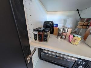 a kitchen counter with spices on a shelf at Stardust Big Bend Luxury A-Frame#1 with a fab view in Terlingua