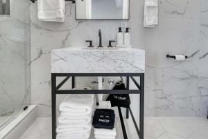 a bathroom with a sink and a white marble counter at Stardust Big Bend Luxury A-Frame#1 with a fab view in Terlingua